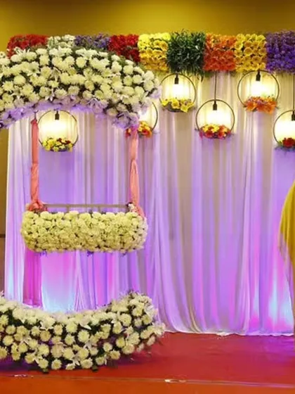 Welcome the little one with our beautiful naming ceremony decor. This crescent moon arch, covered in white flowers and paired with a matching cradle and hanging lanterns, is one of our most requested designs for this special day.