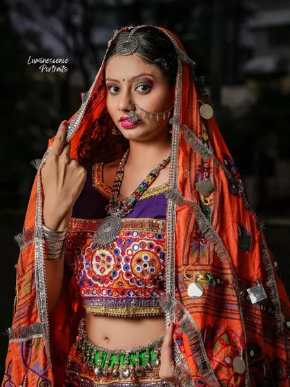 A stunning portrait of a woman in a vibrant, traditional Gujarati outfit, marking the end of the Navratri series.