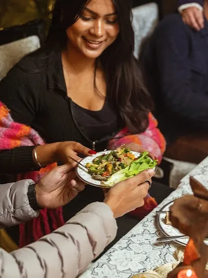 A guest being served a plate of fresh, vibrant salad during a sit-down dinner. I focus on using quality ingredients and beautiful plating to elevate every dish in a multi-course meal.
