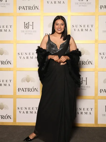 Attending a Suneet Varma showcase in a classic black pre-draped saree with a sequined blouse and a feather stole. This look is all about sophisticated glamour with a touch of drama.