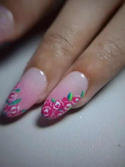 A full view of the pretty pink manicure with floral accent nails.