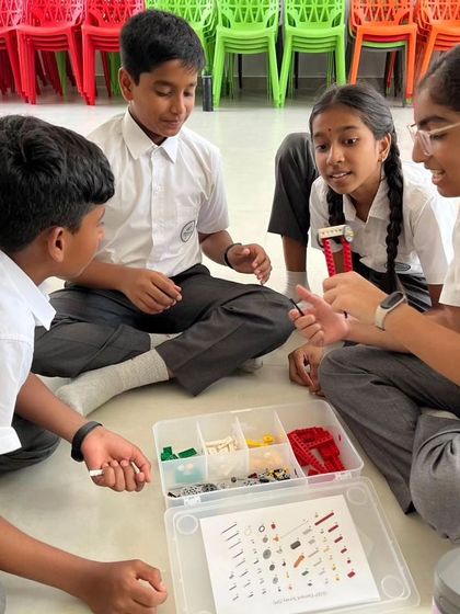 A group of students from Sadhu Vaswani International School discusses their project, demonstrating the communication and collaboration skills fostered in our workshops.