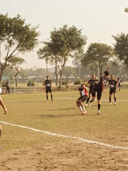 A player executes a powerful header during a competitive match in the Super League. This shows the aerial dominance we train for.
