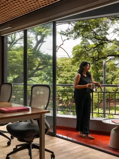 In our design for the Ulsoor workspace, we brought the warmth of Old Bangalore indoors. A balcony with red oxide flooring opens up to the lush canopy of a raintree, making the natural context an active participant in the daily life of the office.