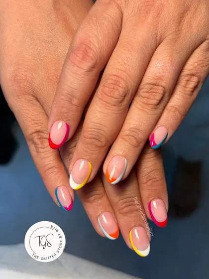 Perfect for a vacation, this is a fun and colorful take on the French manicure. Each nail features a different bright neon color on the tip for a playful rainbow effect.