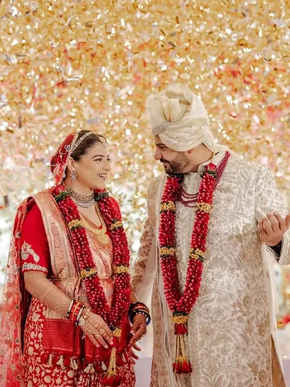 A shower of golden confetti rains down on the couple right after their Varmala. We love using special effects to elevate key moments and create picture-perfect memories.