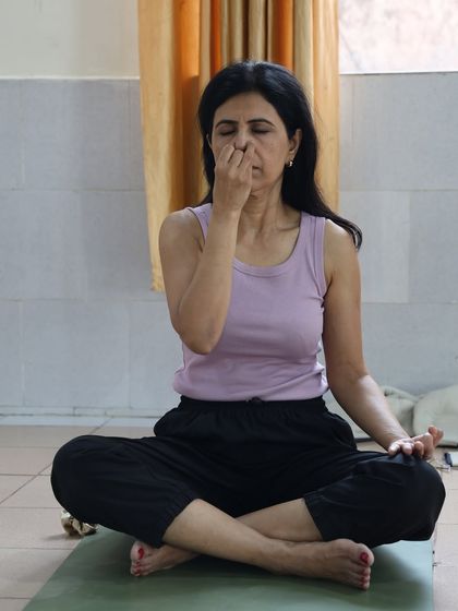 The practice of pranayama helps to banish sluggishness and lethargy. This student is focused on her breathing to boost her energy levels and feel a sense of lightness.