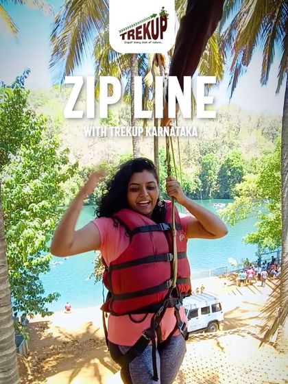A happy trekker enjoying the zip line activity in Dandeli, one of the many adventures we offer.