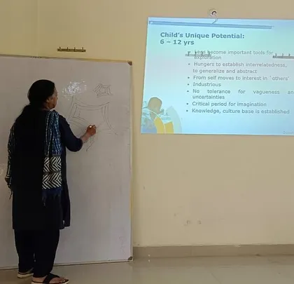 Our founder uses a whiteboard to illustrate a concept about a child's unique potential, combining presentation with interactive teaching.