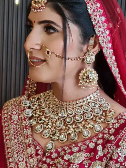 A side profile of my pretty bride, showcasing her flawless base and the intricate details of her jewelry and hairstyle.