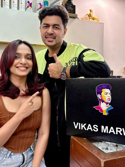 A shot with my happy client, pointing to her new red-violet hair. It’s always a great moment when a client loves their transformation and feels ready to take on the world with their new look.