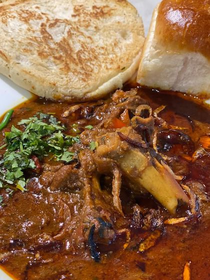A rich and aromatic Mutton Nihari, slow-cooked until the meat is fall-off-the-bone tender. We serve it with soft pav, perfect for soaking up the delicious gravy.