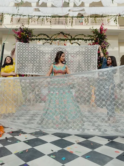 A mehendi entry that is full of fun and personality. I choreographed this playful entrance where the bridesmaids used a delicate veil to tease the groom before the bride's big reveal, adding a touch of lighthearted banter to the daytime celebration.