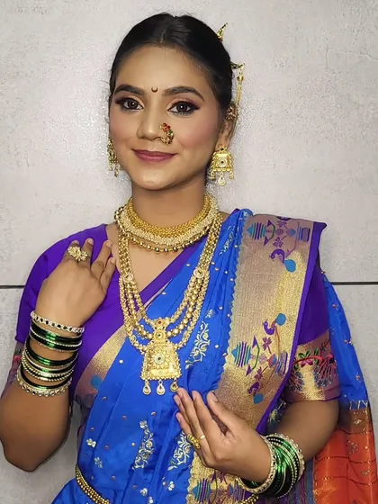 This Gudi Padwa look combines a classic blue Paithani saree with fresh, dewy makeup and traditional gold jewelry for a timeless appeal.