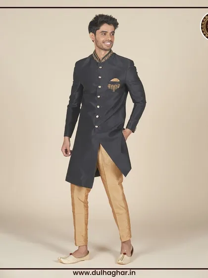 Another view of the black and gold Indo-Western outfit, highlighting its sharp, asymmetrical cut.