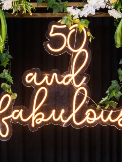 The "50 and fabulous" neon sign was a key element in this surprise celebration. It created a fun and glamorous focal point for photos and perfectly captured the spirit of the event.
