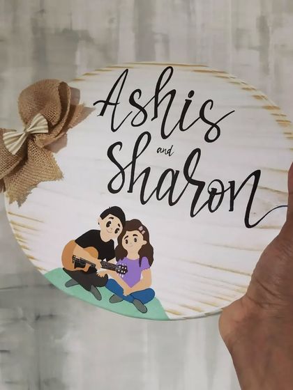 We love bringing personal stories into our art. This name plaque for "Ashis and Sharon" features a hand-painted replication of an illustration from their wedding invitation, a truly special gift.