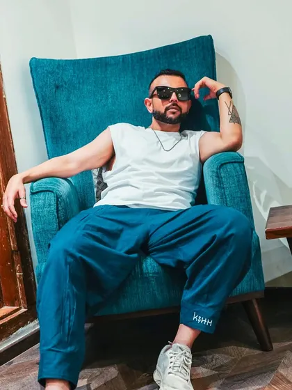 I'm not in your inbox. A cool, relaxed shot of me in a chair, exuding confidence and a bit of that 'badmaashi' attitude.