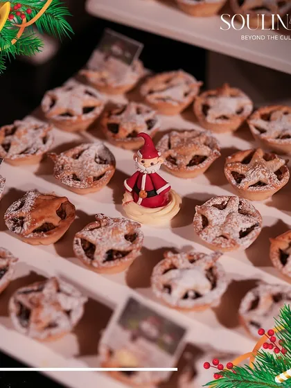 Adorable Christmas mince pies, some topped with a miniature Santa, ready for a holiday party. Our pastry chefs add a touch of whimsy and delight to our festive dessert offerings.