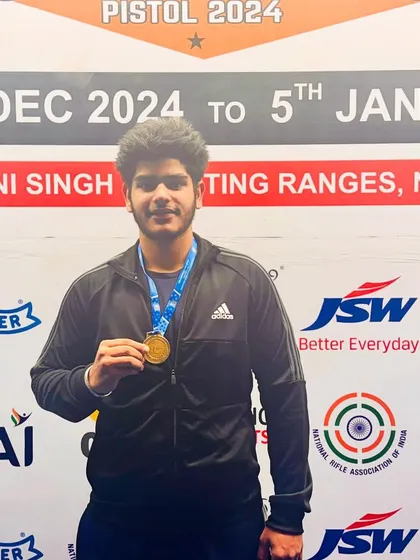 National Champion Daksh Choudhary proudly posing with his gold medal. His victory is a result of dedicated practice in the 25m pistol discipline.