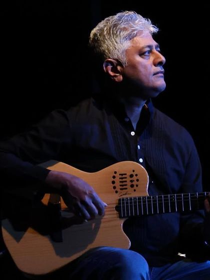 A fellow musician playing the guitar during our 'Jugalbandi' concert. The fusion of Indian and Italian instruments created a truly unique and beautiful soundscape.
