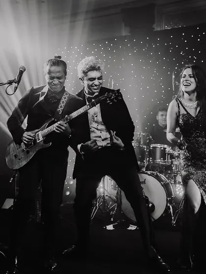 The bride and groom rocking out on stage with the live band. I love capturing these high-energy, unexpected moments.