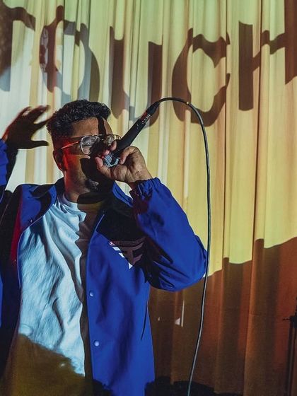 Caught in the moment at Saket Social. The spotlight's on, and I'm ready to spit fire.