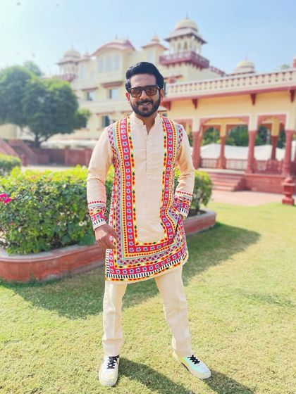 A vibrant, multi-coloured kurta for a Haldi ceremony in Jaipur. The traditional Rajasthani patterns and bright colours perfectly match the festive and joyful occasion.