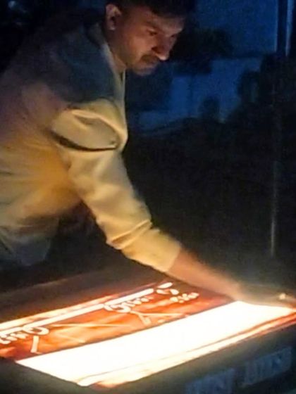 A focused moment during the biographical show for Anand Group's founder. Each movement of the hand is precise to bring the story to life.