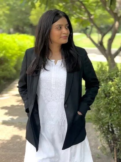 Walking through a park, combining professional attire with a moment in nature. This balance helps me stay grounded and focused.