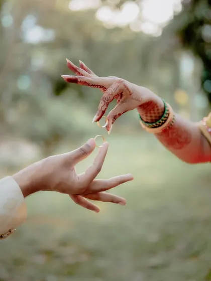The ring exchange is more than just a ritual; it's a promise. I love finding creative ways to photograph this moment, focusing on the delicate hand gestures and the beautiful henna that tells its own story.