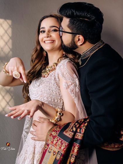 A genuinely happy and candid moment from an engagement, with the bride showing off her new ring with a huge smile.
