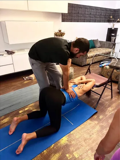 Using a chair as a prop is a great way to work on shoulder and upper back flexibility. I'm applying gentle pressure to help my student open her thoracic spine.