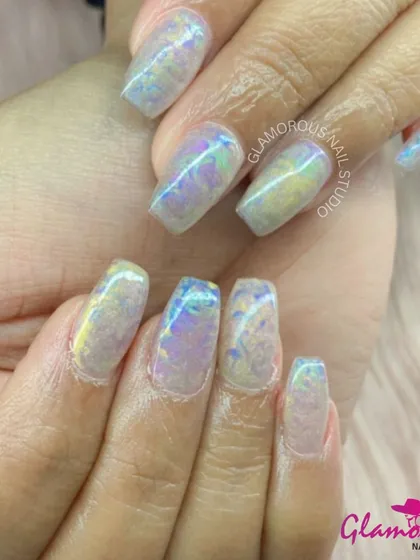 A magical, iridescent look. These nails have a "shattered glass" or "unicorn skin" effect, reflecting a rainbow of pastel colors. It's a dreamy and ethereal design that is truly unique.