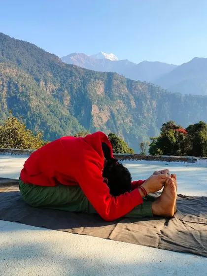 A still image capturing the deepest point of Paschimottanasana. This pose is not about touching your toes, but about lengthening the spine and releasing tension in the hamstrings and lower back.