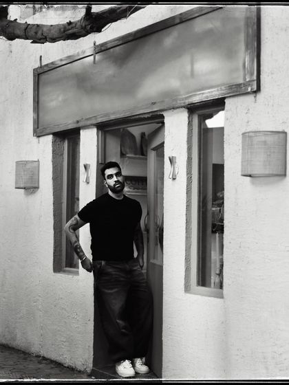 Tej, standing in the doorway of his shop. This portrait captures him in his element, grounded and confident.