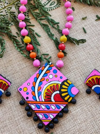 A pretty pink version of the diamond-shaped pendant necklace, with a string of matching pink and multi-color beads.