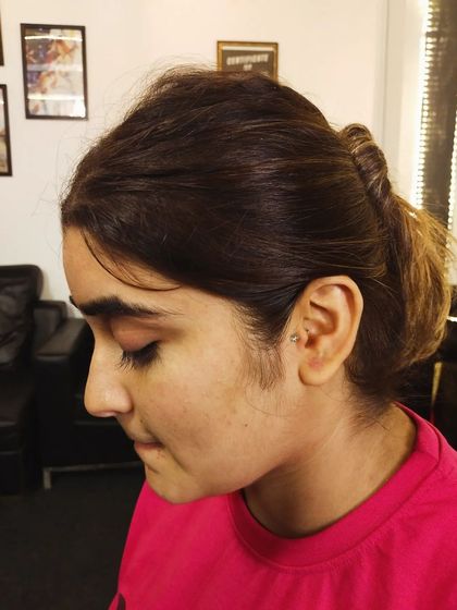 A wider view of the client with her new tragus piercing, showing how it fits into her overall style.