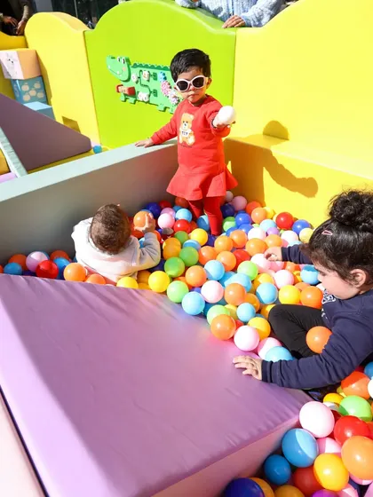 Playing in style! This little one is having a blast in our multi-colored ball pit.
