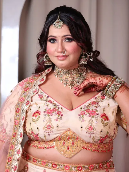 A portrait of the plus-size bride, her eyes sparkling with happiness. The intricate embroidery on her blouse is a work of art.