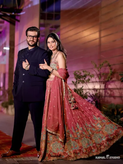 A stylish portrait of the couple at their Roka, their coordinated outfits and confident pose making a statement.