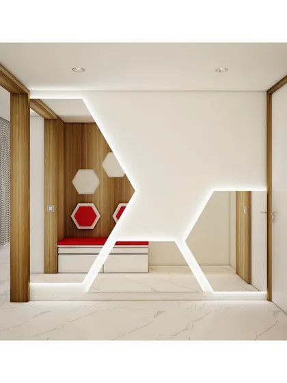 A striking geometric feature wall at the entrance, with integrated lighting and a red hexagonal seating nook. This creates a bold architectural statement right from the foyer.