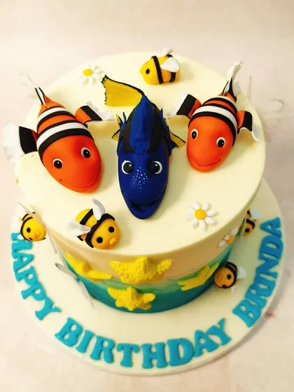 A top-down view of our Dory cake, showing the friendly faces of the beloved clownfish and blue tang, ready for a birthday adventure.