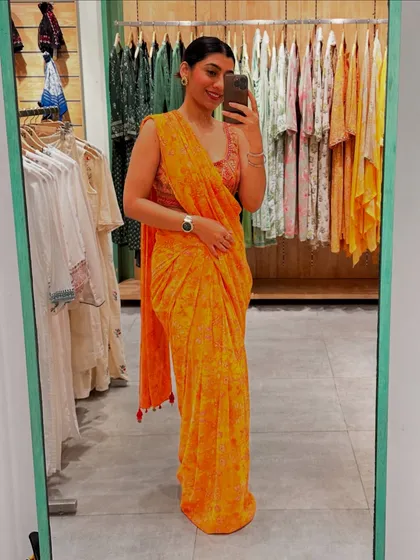 A beautiful printed orange saree, perfect for a bright and cheerful festive occasion.