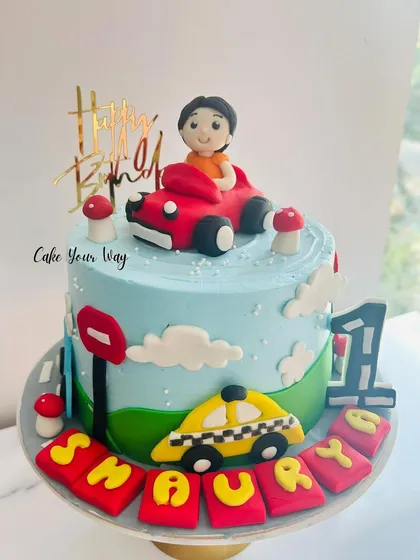 A year of joy and just the beginning. This car-themed first birthday cake is full of playful details.