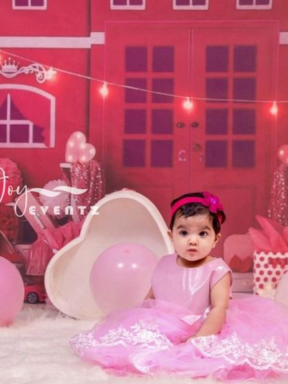 A princess-perfect Alcazar theme for a baby girl's photoshoot. The set features a pink castle backdrop, string lights, and heart-shaped props, creating a fairytale scene for your little royalty.