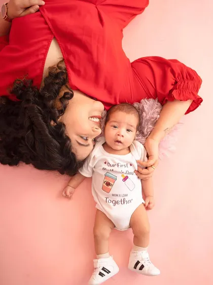 "Our First Mother's Day Together." This creative flat-lay style portrait is a unique and adorable way to commemorate such a special milestone for a new mom and her baby.