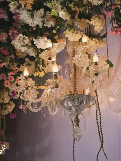 A close-up of a crystal chandelier dripping with flowers. This detail shows how I blend classic luxury with natural beauty to create unique and stunning decor pieces.