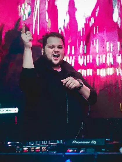 An expressive shot of me with my hand in the air, feeling the peak of a track.