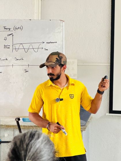 A coach presents a graph showing fitness and maintenance phases over time. This level of detailed planning is what sets our programs apart.
